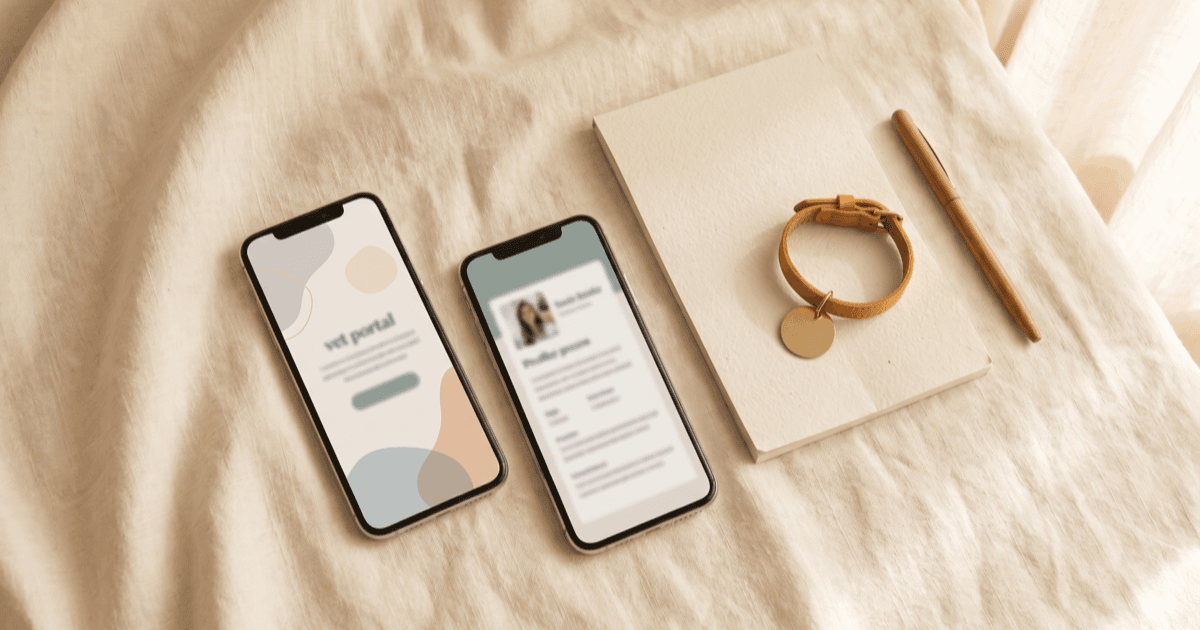 A flat-lay on warm cream linen of two smartphones side by side with calm minimal screens (vet-portal-style and owner-profile-style), a folded paper notepad, a small leather pet collar with a blank tag, and a pen.